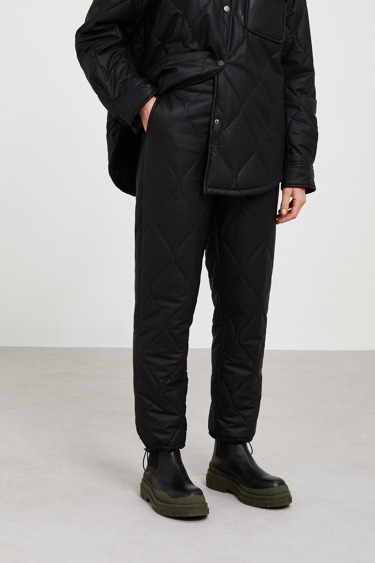 Leather-finish quilted trousers